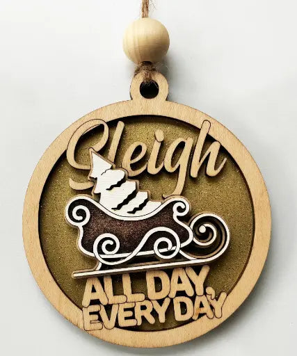 Elegant round wooden ornament with a sleigh design and the text "Sleigh All Day Every Day" for festive holiday decoration.